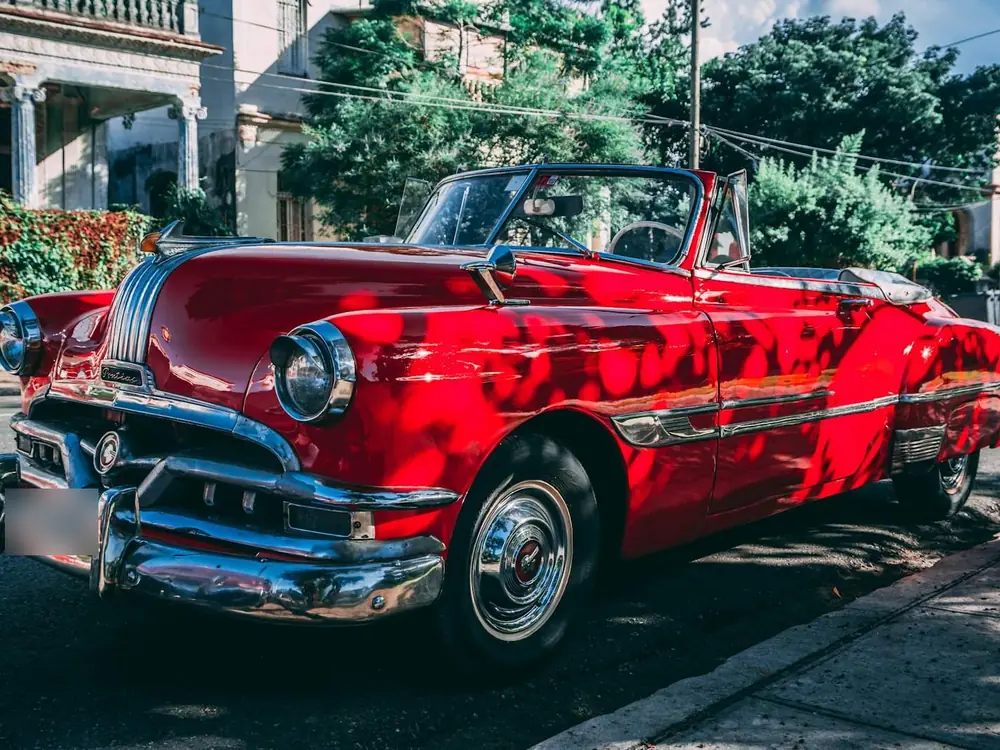 Red vintage convertible parked on a street
